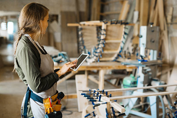 Craftsperson using a tablet in a woodworking shop